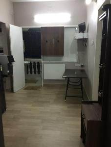钦奈Avvairam Service Apartment - C9的客房设有带书桌和橱柜的厨房。