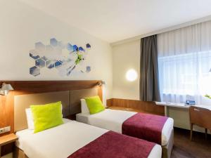 维尔纽斯维尔纽斯宜必思尚品酒店的酒店客房设有两张床和窗户。