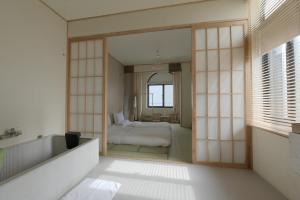 上海途宿臻选·二更酒店（上海新天地田子坊店）的一间带镜子、一张床和浴缸的浴室