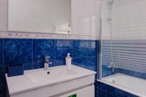 加亚新城Classico Guesthouse的浴室配有盥洗盆、镜子和浴缸