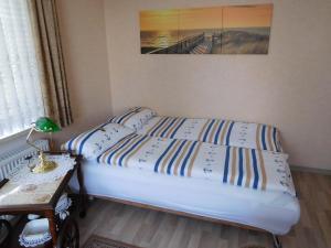 库克斯港Ferienwohnung-Kuestensnack的一间卧室配有两张床和一张带台灯的桌子