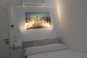 马德里Hostal royal begoña的卧室,墙上挂着一张照片,位于床上方
