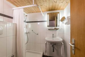 库尔Hotel Stern Chur的白色的浴室设有水槽和淋浴。