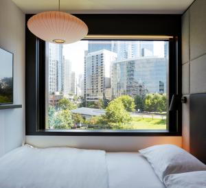 西雅图citizenM Seattle South Lake Union的一间卧室设有窗户,享有城市美景