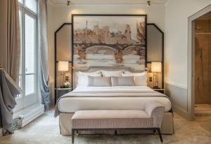 巴黎Hôtel Elysia by Inwood Hotels的一间卧室配有一张大床,墙上挂着一幅大画