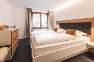 采尔马特Central & Elegant Apartments,partially with Fireplace, by Zermatt Rental的一间卧室设有一张大床和一个窗户。