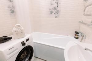 博布鲁伊斯克PaulMarie Apartments on Gor'kogo 41的白色的浴室设有水槽旁的洗衣机