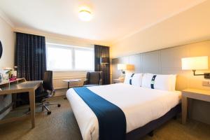 佩斯利假日格拉斯哥机场酒店的酒店客房设有一张大床和一张书桌。