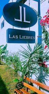 比亚瓜伊Hotel Las Liebres的长凳旁的一块花边标志