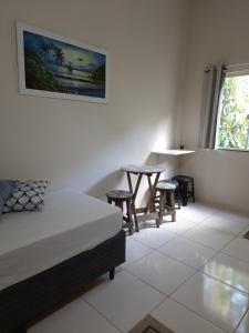 阿布拉奥Flats Jordão的卧室配有一张床和一张桌子及椅子