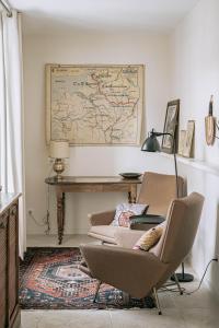 南希Les Suites de Catherine, la 35的一间设有两把椅子和一张桌子的房间,墙上有一张地图