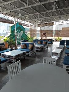 吉隆坡Birdnest Guesthouse, Gaia Rooftop Cafe的大楼内带桌椅的天井