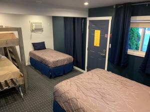 雷夫尔斯托克Peaks Lodge的客房设有两张床和一扇窗户的门