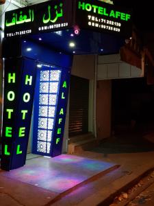 突尼斯Hotel Afef的黑暗中 ⁇ 虹灯标志的酒店客房