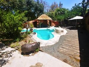 赫卢赫卢韦Pumusa Bushcamp的一个带凉亭的庭院内的游泳池