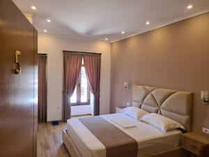 培拉特阿尔本埃勒兹旅馆的一间卧室设有一张大床和一个窗户。