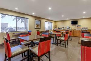 凤凰城Comfort Inn & Suites Phoenix North - Deer Valley的一间带桌椅和电视的餐厅