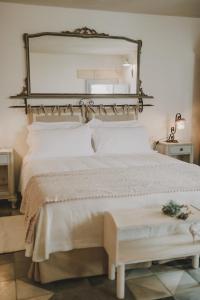 法萨诺蒙坦亚珀利昂农场酒店的卧室配有大镜子,位于床上方