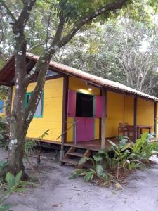 伊尔哈德博伊巴Casinha Amarela Chales Boipeba的黄色的房子,上面有色彩缤纷的油漆