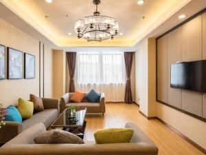 江阴格林豪泰无锡江阴市人民东路良晨广场商务酒店的带沙发和平面电视的客厅