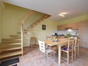 齐罗Cozy 5-bedroom Holiday Home in Zierow with Garden的厨房以及带桌子和楼梯的用餐室。