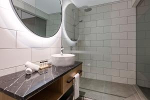 惠灵顿Hotel Room @ 89 Courtenay Place的一间带水槽和镜子的浴室