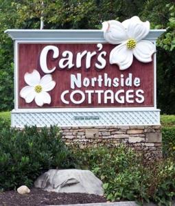 加特林堡Carr's Northside Hotel and Cottages的花在北边的 ⁇ 车小屋的标志