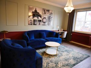 韦斯特罗斯阿卡德酒店的客厅配有蓝色的沙发和桌子