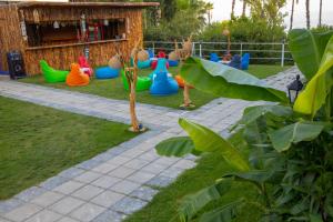 基兹洛特Aroma Butik Hotel的儿童游乐场,在草地上摆放着五颜六色的塑料玩具