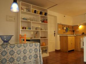 隆达卡萨坎德拉度假屋的一间厨房,内设白色的架子和一张桌子