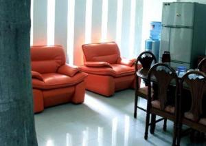 泗水Soerabaja Place Guest House的客厅配有两把椅子和一张桌子