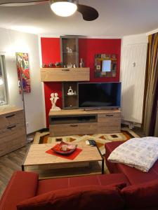 汉诺威Ferienwohnung Artemis的客厅配有平面电视和红色墙壁。