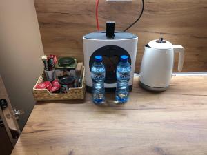 瓦尔纳Your Place Apartment的咖啡壶和柜台上的两瓶水
