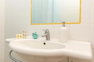 阿尔比尼娅Argentario Garden House的浴室设有白色水槽和镜子
