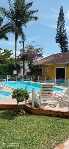 贝卢港贝卢港花园旅馆的房屋前带躺椅的游泳池