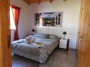 门多萨Cabañas Mirmar Mendoza的卧室里设有一张床,上面有一只动物