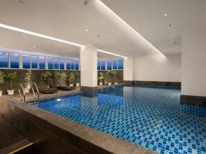 加拉旺favehotel Karawang的蓝色瓷砖的酒店游泳池
