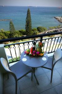 利马索尔码头海滩公寓酒店的阳台上的鲜花桌