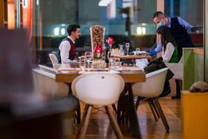 卢加诺Hotel Delfino Lugano的一群坐在餐厅桌子上的人