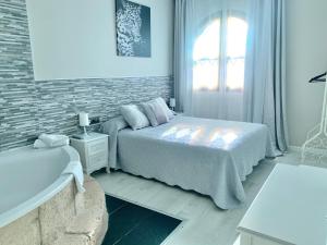 佩多拉卡斯蒂略博纳维亚酒店的白色的卧室设有床和窗户