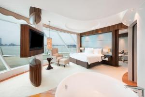 苏州苏州中茵皇冠假日酒店的游艇上的卧室配有床和电视