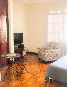 EscazúEster`s Place的一间卧室配有一张床、一把椅子和一张桌子