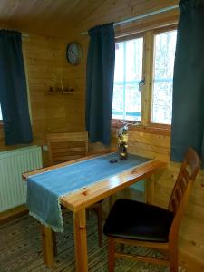 阿克雷里Bakkakot 2 - Cozy Cabins in the Woods的用餐室配有带蓝色布的木桌