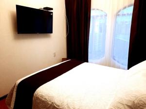 Hotel Boutique La Albertina客房内的一张或多张床位