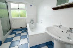 安布尔塞德Pye Howe的浴室配有盥洗盆、浴缸和盥洗盆
