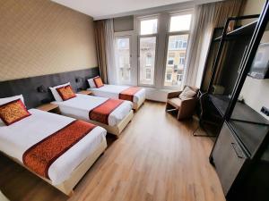 阿姆斯特丹华盛顿酒店的酒店客房设有两张床和电视。
