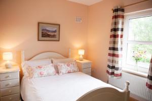 GrangeInviting 4-Bed House in Strokestown的卧室配有白色的床和窗户。