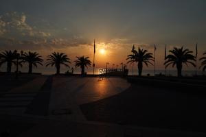 帕拉利亚卡泰里尼斯利拉鲁酒店的大海前棕榈树的日落
