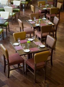 阿伯丁Leonardo Hotel Aberdeen的用餐室配有桌椅和酒杯