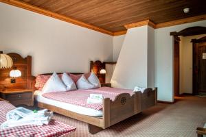 格林德尔瓦尔德Hotel Gletscherblick Grindelwald的一间卧室设有一张床和木制天花板